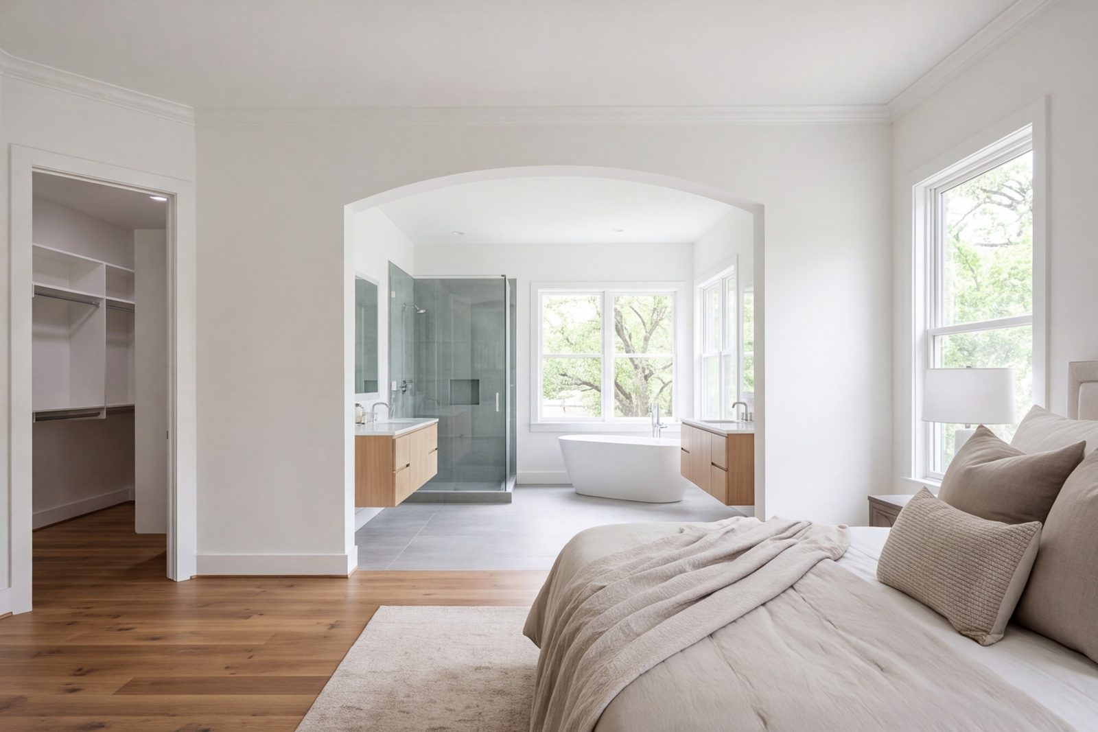 Lakewood primary suite with bedroom, walk-in closet and bath seen as one calm space